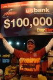 Pro Kelly Jordon of Mineola, Texas, shows off his first-place check after winning the FLW Tour event on Lake Okeechobee.