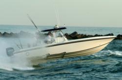 A kingfish boat takes off at the Fort Pierce inlet.
