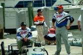 The Watts brothers, Bryan and Greg, wait at the dock to weigh their fish as eventual tournament winner Rick Murphy walks by. The Watts ultimately finished ninth.