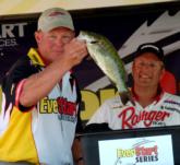 As Chris Cox looks on, pro Jeff Ritter of Prairie du Chien, Wis., finishes fourth with a final weight of 24 pounds, 12 ounces.