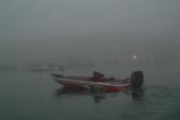 A competitor cuts through the fog before day-one takeoff on Lake Amistad.