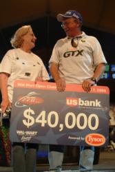 Richard Strother proudly displays his winning check after netting the co-angler tournament title on Beaver Lake. Strother shared the stage with his wife, Pat.