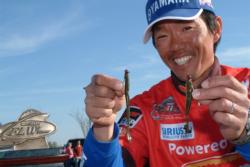 Shinichi Fukae holds up his tournament winning lures: a Yamamoto 5-inch Cut-Tail worm and a 4-inch Yamamoto shad-shaped worm, both fished on a 3/32 ounce jighead with 8-pound test line.