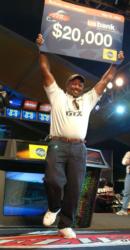 Tyrone Phillips jumps for joy as he holds up his $20,000 check for his co-angler win.