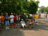 Bass fishing fans attempt to avoid the heat by sitting in one of the few shady spots at Wednesday