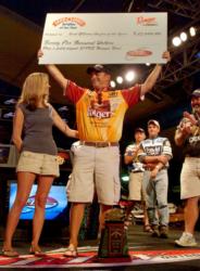 Flanked by his wife, Kristin, and his fellow pro anglers, Anthony Gagliardi accepts $25,000 from Land O