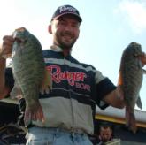 Bryan Coates shows the crowd a pair of bass from his 18-pound, 3-ounce catch that put him in fifth.