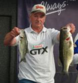 Runner-up co-angler Edwin Loitz displays a pair of bass that pushed his day-two total to 7-15. His two-day weight clocked in at 16-4.