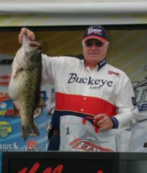 Rick Turner hoists the heaviest bass caught in FLW Outdoors history - a 14-pound, 8-ounce Lake Amistad monster.