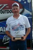Co-angler Jimmy Ballard holds the trophy from a history-making win on Lake Amistad.
