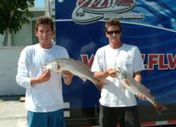 Cody Chivas and Kyle Chivas hold up their two biggest redfish from Thursday's competition.