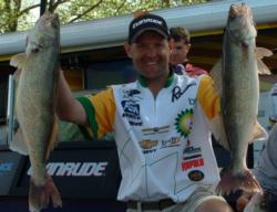 BP pro Jason Przekurat holds up his two biggest walleyes from day one on the Mississippi River.