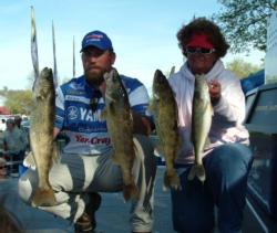 Pro Robert Crow and co-angler Sally Blain hold up their walleyes from day one.