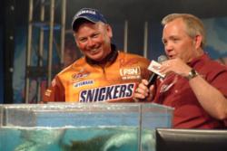 Pro J.R. Beehler of Bella Vista, Ark., shares a laugh onstage with tourney host Charlie Evans. Beehler is gettting set to fish in his first-ever FLW Tour finals on Sunday.