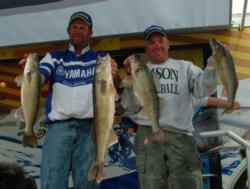 Ron Erhard and Henry Juntunen hold up their leading limit of Devils Lake walleyes.