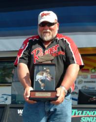 Pete Harsh displays his trophy for winning the FLW Walleye Tour qualifier on Devils Lake.