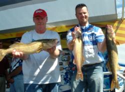 Pro Jason Kerr and co-angler Phil Milliser hold up their day-one catch from Bays de Noc.