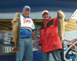 Steve Vande Mark and Trent McLaughlin hold up their winning walleyes from Big Bay de Noc.