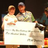 KATV Channel 7 Big Bass Challenge winner Ruth Woodruff poses with her $500 check and her pro partner Craig Powers.