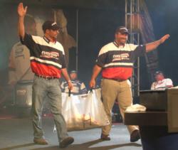 Pro Scott Fairbairn and co-angler Adam Adler wave to the Cleveland crowd.