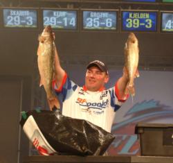 Pro winner Dustin Kjelden holds up his two biggest walleyes from day four on Lake Erie.