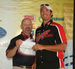 Pro Lee Batson holds up his fourth-place check worth $6,500.