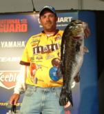 M&M's pro Pat Fisher holds up his kicker bass from day two on Lake Toho. 