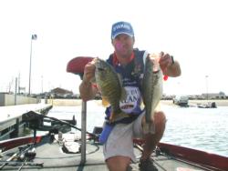 Dave Andrews hoists a smallmouth and a largemouth caught on the second day of Wheeler Lake competition in the FLW Series.