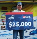 Kentucky/Barkley winner Bobby McMullin holds up his $25,000 check.
