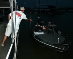 An FLW staffer tosses an ID float to a co-angler during boat check.
