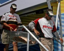 Fourth place anglers Sal Fontana and Tony Grose carry their catch from the weigh-in stage.