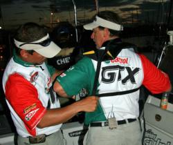 Tony Grose helps hs partner Sal Fontana strap up his PFD. Sitting a little over a pound out of the lead, the second-place anglers hope to close the distance on day three.