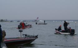National Guard FLW College Fishing anglers watch as the top 10 Stren pros blast off through the open waters of Falcon Lake. 