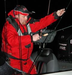 Co-angler Derrick Martineau rigs up a rod in the pre-launch darkness.