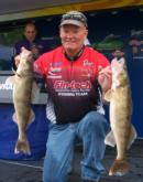 Fourth-place pro Barry Walker holds up two nice Mississippi River walleyes he caught on day three.