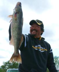 Pro winner Ted Takasaki holds up his kicker walleye from day four on the Mississippi River.