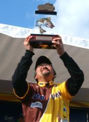 Ted Takasaki holds up his trophy for winning the FLW Walleye Tour event on the Mississippi River.