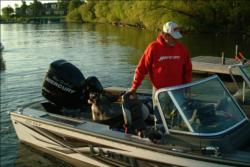 With help from his dog Dufus, Ron Seelhoff of Burlington, Colo. launches on day one of the Walmart FLW Walleye Tour tournament on Leech Lake.