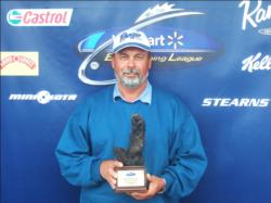 Co-angler Sheldon Ayers of Anna, Ill., shows off his first-place trophy after winning the BFL Illini Division event on Lake Shelbyville.