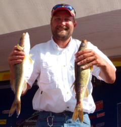 Iowa boater Zack Kovar holds up his two biggest walleyes from day two on Lake Wissota.