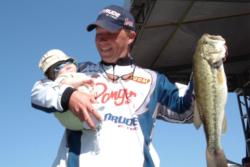 Pro Andy Montgomery of Blacksburg, S.C. Montgomery shows off his catch with a little one in tow. Montgomery finished Wednesday's competition with a total catch of 14 pounds, 5 ounces.