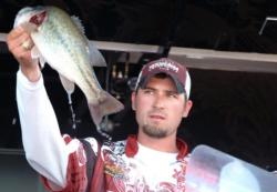 Texas A&M team member Paul Manley proudly displays his catch en route to a third place qualifying performance at the 2010 FLW College Fishing National Championship.