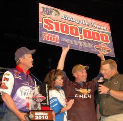 TBF National Championship winner Jay Keith hoists his victory check after his big performance on Watts Bar.