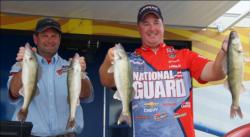 National Guard pro Mark Courts and co-angler Bryan Bayerkohler hold up four nice Devils Lake walleyes.