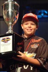 TBF Junior World Championship competitor Shane Edgar of Arizona shows off his first-place trophy after winning the 11-14 age group.