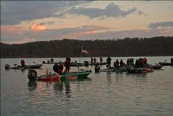 Anglers pause for the national anthem at the start of day one.