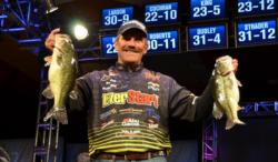 Pro leader Ron Shuffield holds up his two biggest bass from day three on Beaver Lake.