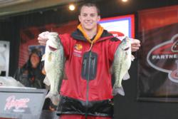 A drenched but happy Ryan Latinville holds up two bass that helped him move from third to first in the Eastern Division. For his efforts, Latinville earned a slot in the final day of the TBF National Championship.
