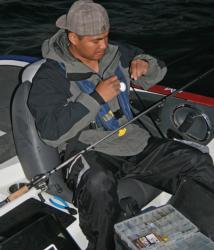 Co-angler Rommel Bagay ties a Texas rig as he waits for the day one take-off.