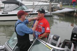 Tournament leader Jeff Graves gets wired for the television cameras on the final morning of the National Guard FLW Walleye Tour event on Lake Erie.